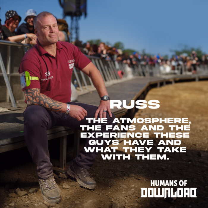 Download security Russ striking a pose with caption text: 'The atmosphere, the fans and the experience these guys have and what they take with them.' - Russ - Humans of Download