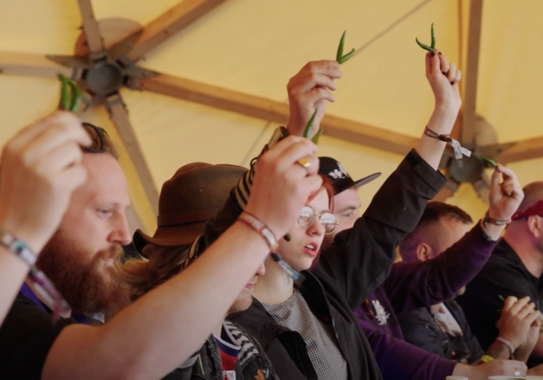 Group of festival go-ers holding chilli's