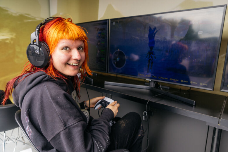 Festival go-er playing a video game at game station