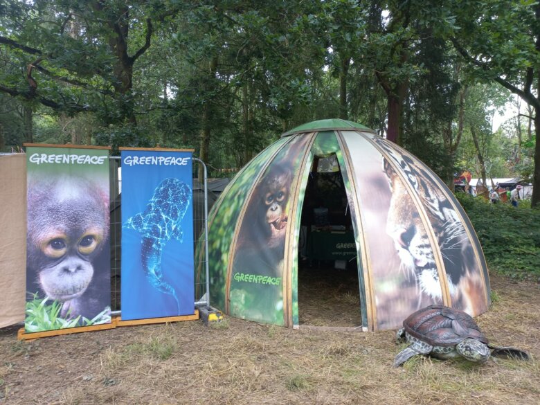 Greenpeace's stall at #DLXXII including a tent and banners