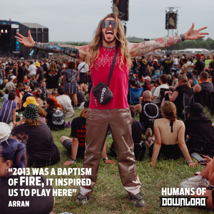Arran striking a pose with caption text: '2013 was a baptism of fire, it inspired us to play here' - Arran - Humans of Download