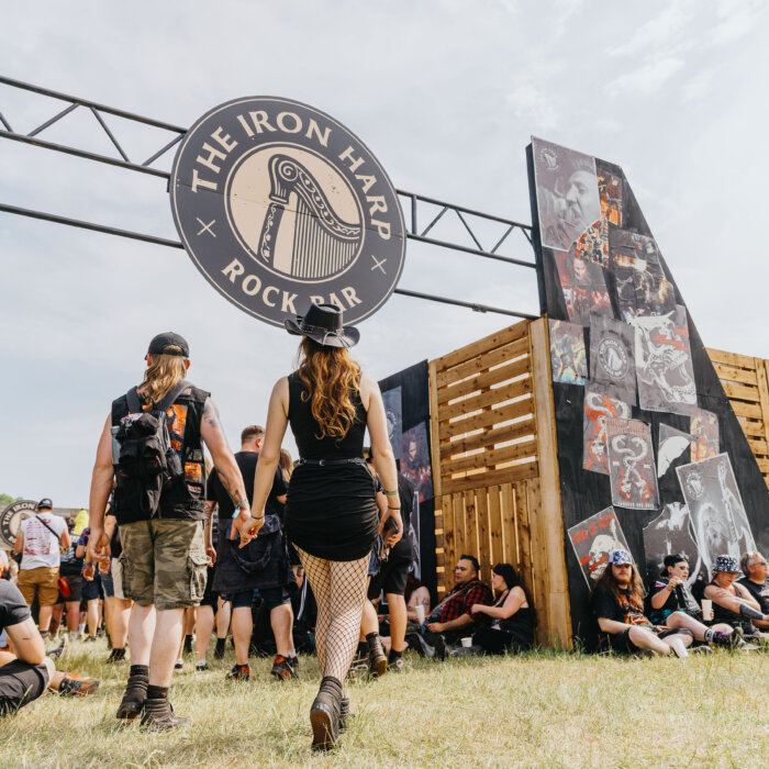 Download fans walking towards the Iron Harp bar.